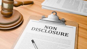 Wooden Lawyer Desk with Highlighted Word 'NON DISCLOSURE' on Clipboards Documents on Table. Judge's Wooden Gavel Knocking and Court Making Decision on 'NON DISCLOSURE' in Courtroom. video