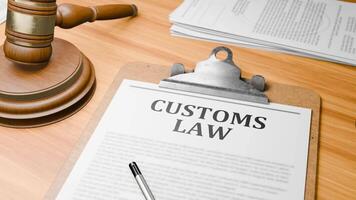 Wooden Lawyer Desk with Highlighted Word 'CUSTOMS LAW' on Clipboards Documents on Table. Judge's Wooden Gavel Knocking and Court Making Decision on 'CUSTOMS LAW' in Courtroom. video