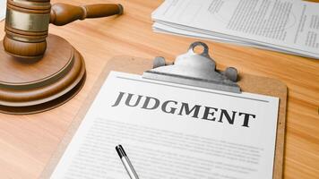 Wooden Lawyer Desk with Highlighted Word 'JUDGMENT' on Clipboards Documents on Table. Judge's Wooden Gavel Knocking and Court Making Decision on 'JUDGMENT' in Courtroom. video