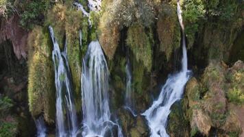 Aerial view of a small waterfall in the uncontaminated nature. Water, rocks and trees in a natural scenary. video