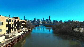 A river with buildings and a bridge in the background video