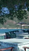 A table and chairs set up on the beach near the water video