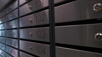 Metal mailboxes with apartment numbers in a multi-story building video