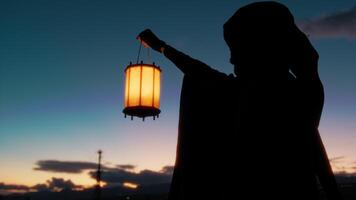 Silhouette Of A Mysterious Man With Cloak And Light Lantern At Sunset Sky video