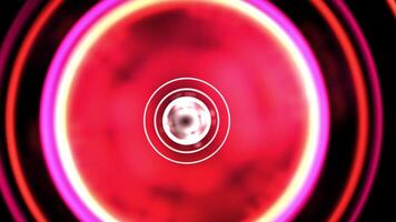 a red and pink circular object with a white center video