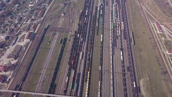 Aerial view of Railway sorting station and A lot of wagons at a railway. Drone flies over railway tracks. 4k quality video
