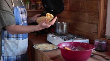 Remove cooked hot pancake from pan by hand without spatula closeup. Grease frying pan with oil. Cooking step, necessary ingredients and utensils, recipe. Home baking is delicious and nutritious food. video