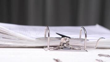 close-up Office worker placing documents binder folder in lever arch file video