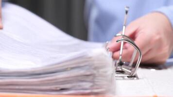 Office worker puts documents in a large filing folder video