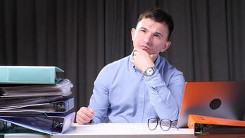 Pensive office worker contemplating next move amidst paperwork overload video