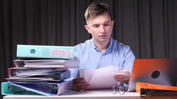 Office worker analyzing documents and working with laptop for 2025 year video