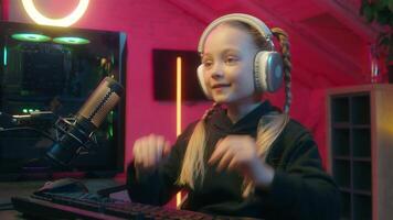 Little Caucasian girl child kid daughter gamer player game addicted dependency playing online internet gaming computer at home evening night neon light win victory receive gold goblet winner video