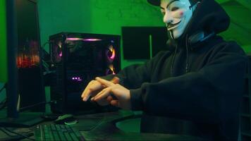 Lviv, Ukraine - June 03, 2024. Hacker warm up hands programming computer professional programmer working pc networking internet software browsing anonymous connection man technology coder device user video