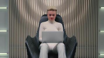 Caucasian woman girl in futuristic studio coder gamer female IT programmer hacker software computer tech support online work laptop modern virtual reality playing game metaverse thumb up like gesture video