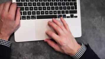 Office worker laptop keyboard and navigating with trackpad, showcasing focused hand movements. Close-up emphasizes precision as laptop usage productivity and seamless interaction with laptop. video