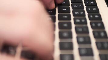 Close-up of hands typing on laptop keyboard emphasizes precision and focus on work. Interaction with laptop keys reflects efficiency and productivity while seamlessly managing tasks on laptop. video