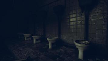 Dark, abandoned restroom with tiled walls and several toilets video