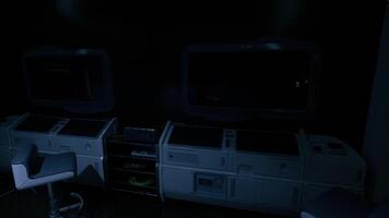 Control room set in dim lighting with screens powered off in a modern structure video