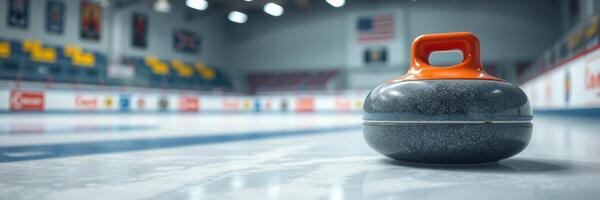 Curling stone positioned on the ice at an indoor curling rink during a competitive match photo