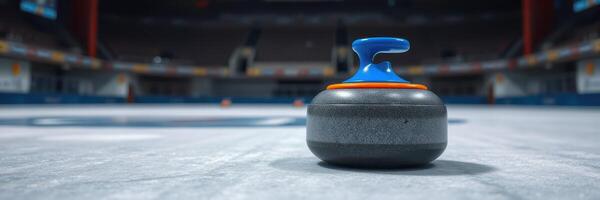 Curling stone on ice at a sports arena during a competition in winter season photo