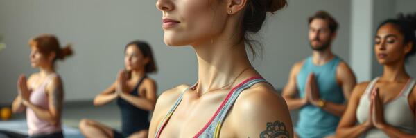 Yoga class participants focus on breathing and mindfulness during a group session in a serene studio setting photo