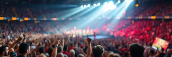 Energetic crowd enjoying a live concert at an indoor arena with vibrant lights and sounds photo