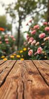Wooden table with vibrant flowers in a garden during a bright afternoon photo