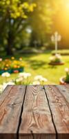 Wooden table in a sunny garden setting with blooming flowers and lush greenery during springtime photo