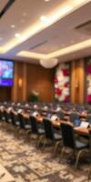 Conference room set up for a business meeting in a modern hotel featuring arranged tables and a presentation screen photo