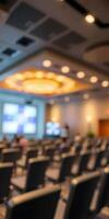 Conference room ready for a business event with rows of empty chairs in a well-lit space photo