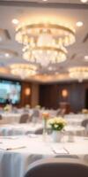 Elegant event space with chandeliers and floral arrangements in a conference room setting during a business gathering photo