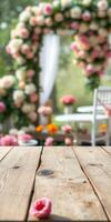 Elegant floral decorations enhance the ambiance of a garden event in springtime with wooden tables and vibrant centerpieces photo