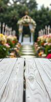Beautiful floral arrangements line the aisle leading to a decorated wedding altar in a serene outdoor setting photo