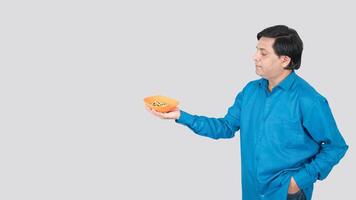 a young boy offering corn cob seeds bowl with right hand. copy space on left side photo