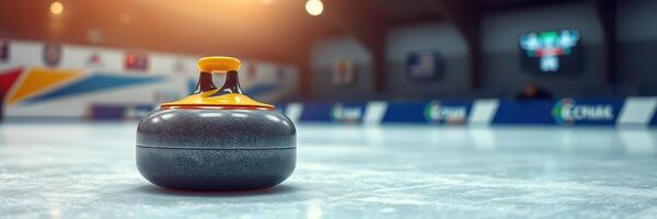 Curling stone on the ice rink during a competitive match in a modern sports arena in winter photo