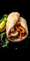 Delicious wrap filled with grilled chicken and colorful peppers on a dark background photo