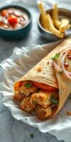 Delicious wrap with seasoned chicken, fresh vegetables, and savory sauces served on a white plate photo