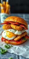 Delicious sandwich with crispy chicken, fried egg, and bacon stacked on a fresh bun at a food establishment photo
