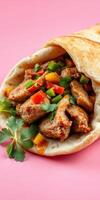 Savory meat wraps filled with colorful vegetables and herbs on a vibrant pink background photo