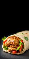Freshly wrapped tortilla filled with grilled chicken, peppers, and herbs ready to be enjoyed at a casual dining spot photo