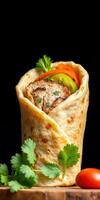 Delicious grilled chicken wrap with fresh vegetables and herbs served in a warm flatbread photo
