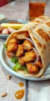 Savory chicken wrap with fresh vegetables served on a plate with sides in a cozy eatery photo