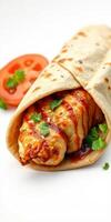 Delicious wrap featuring grilled chicken, spicy sauce, and fresh herbs served with a slice of tomato photo