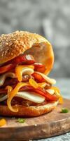Delicious sandwich stacked with layers of savory meat, melted cheese, and fresh vegetables ready to be enjoyed photo