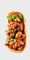 Delicious homemade taco filled with spicy grilled chicken, fresh vegetables, and flavorful sauce photo