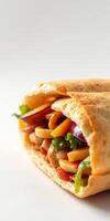 Colorful wrap filled with fresh vegetables and grilled chicken in a soft tortilla on a clean surface photo