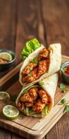 Delicious chicken wraps with fresh ingredients served on a wooden platter photo