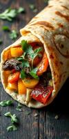 Delicious wrapped burrito with colorful vegetables and herbs on a wooden surface photo