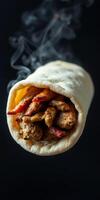 Freshly wrapped pita filled with grilled meat and smoky aroma from the kitchen photo