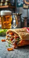 Delicious sandwich filled with grilled meat and vegetables alongside a refreshing beer in a cozy setting photo